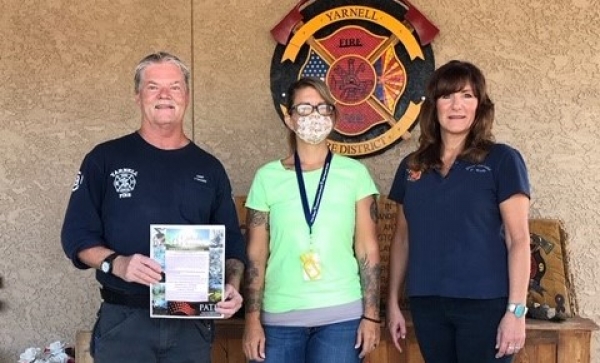 Yarnell Fire Chief Jeff Shearer and Denise Roggio pictured with Pauline Gonzalez